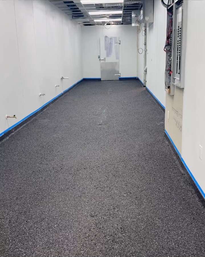 Gray flake flooring system installed in a commercial utility corridor