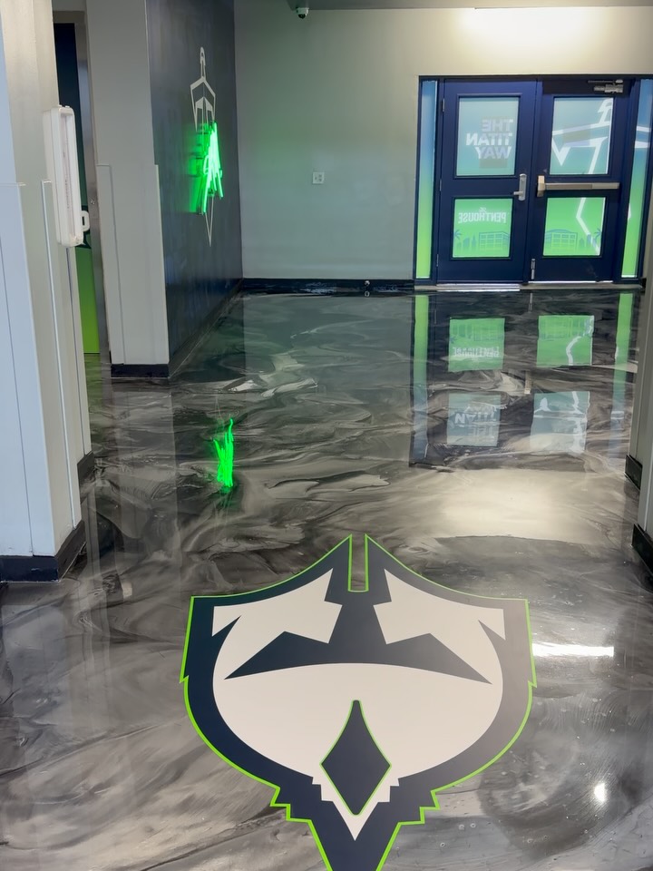 Reflective metallic epoxy floor with a custom sports logo