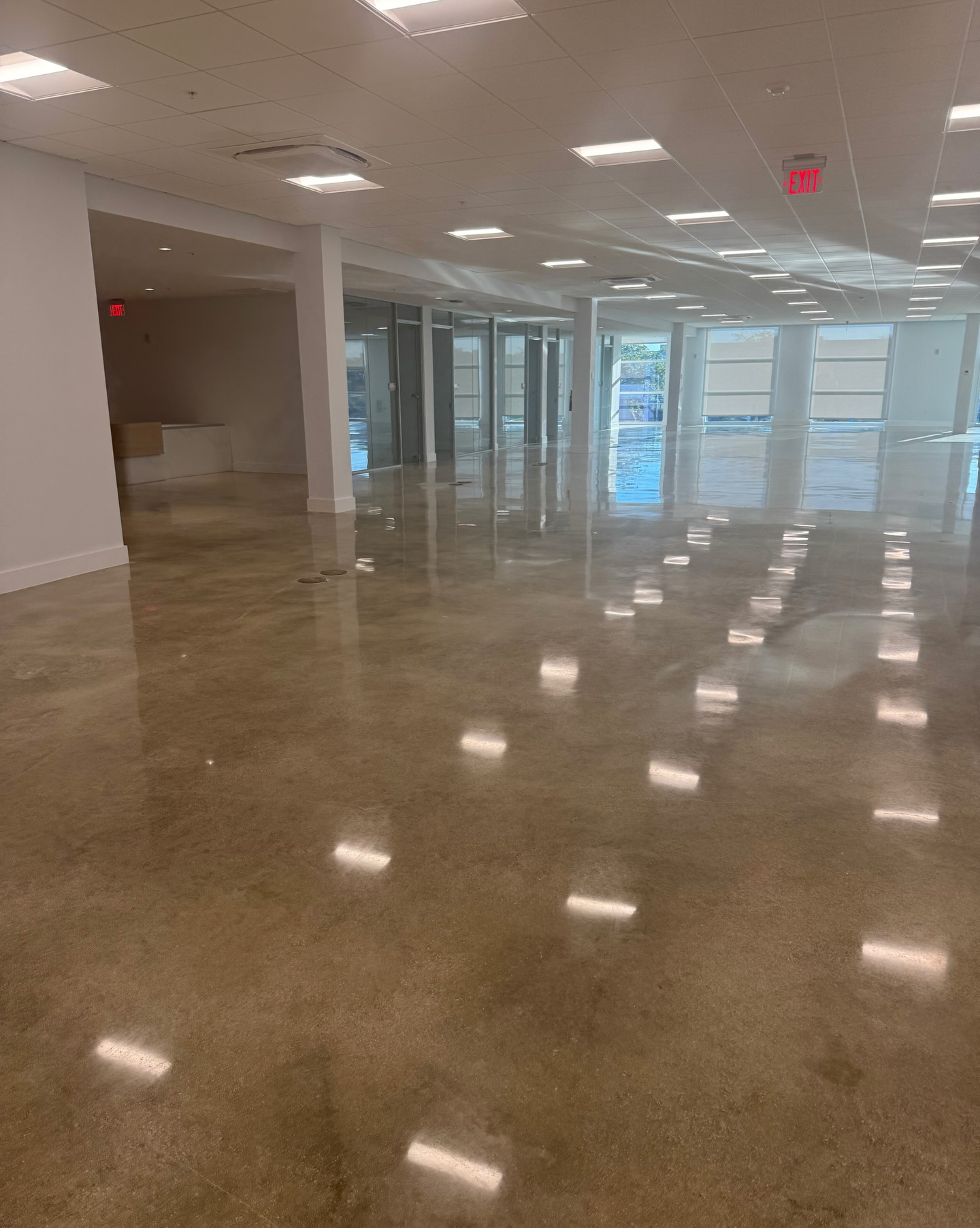 Wide commercial interior with a highly reflective polished concrete floor