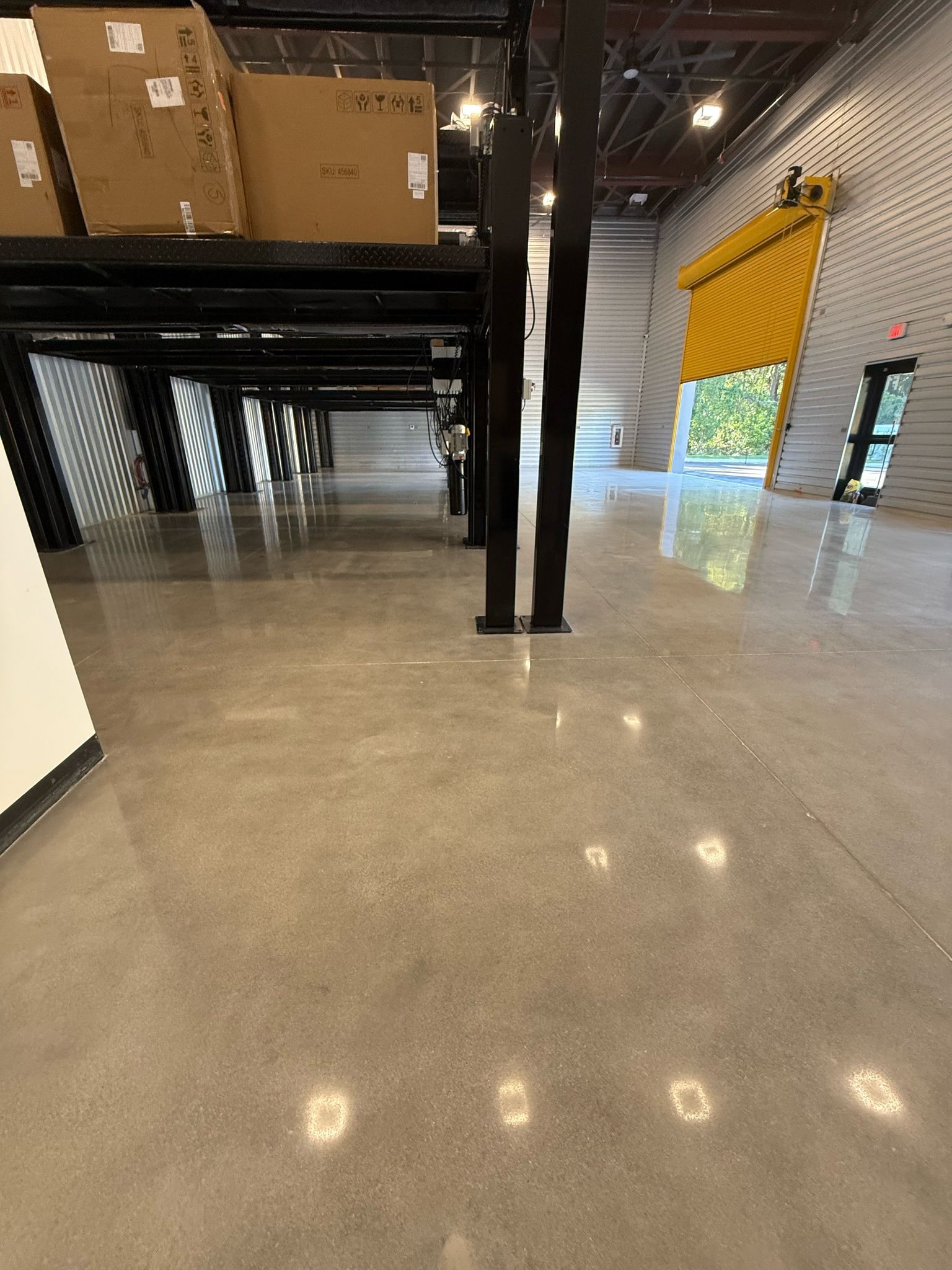 Reflective polished concrete floor inside a working warehouse