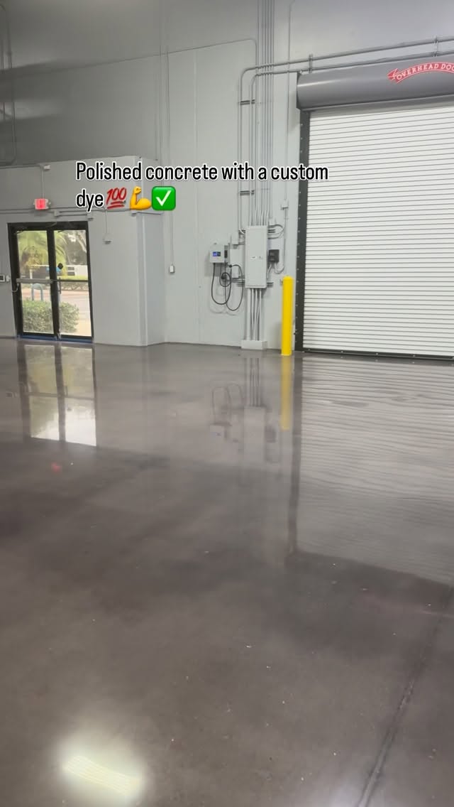 Glossy dyed polished concrete floor inside an industrial warehouse